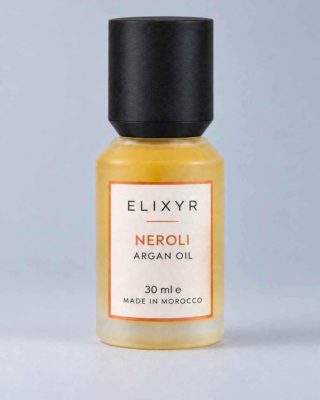 ELIXYR Neroli 30ml fragranced argan oil in frosted glass, with its matte black cap on