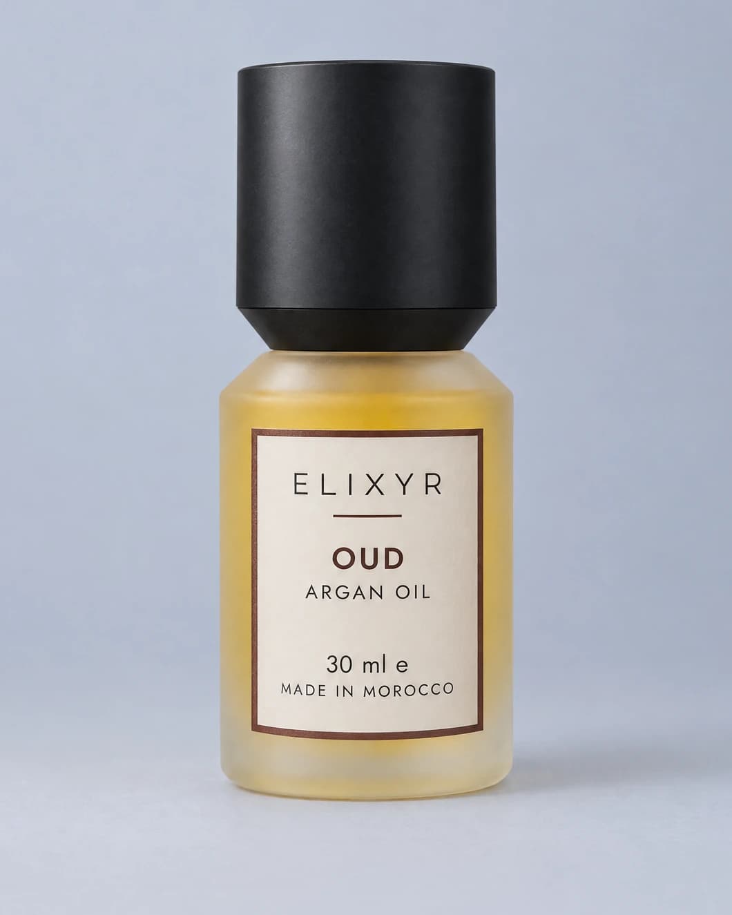 ELIXYR Oud 30ml fragranced argan oil in frosted glass, with its matte black cap on