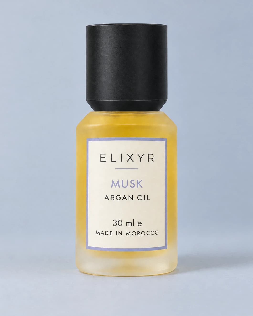 ELIXYR Musk 30ml fragranced argan oil in frosted glass, with its matte black cap on