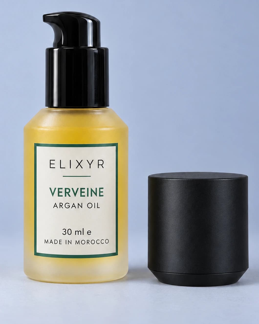 ELIXYR Verveine 30ml fragranced argan oil in frosted glass, glossy black pump exposed with the matte black cap beside it